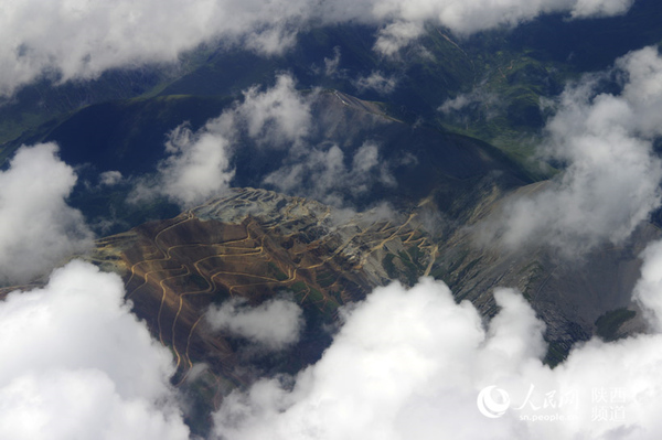 透過云層可見西藏高原地貌 吳超/攝