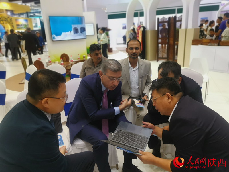 一拍即合，就地而坐，展開合作洽談。人民網(wǎng) 王麗攝