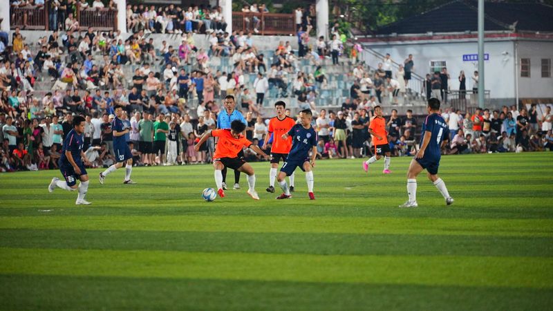 球員們?cè)诰G茵場(chǎng)上奮力踢球。周光勝攝